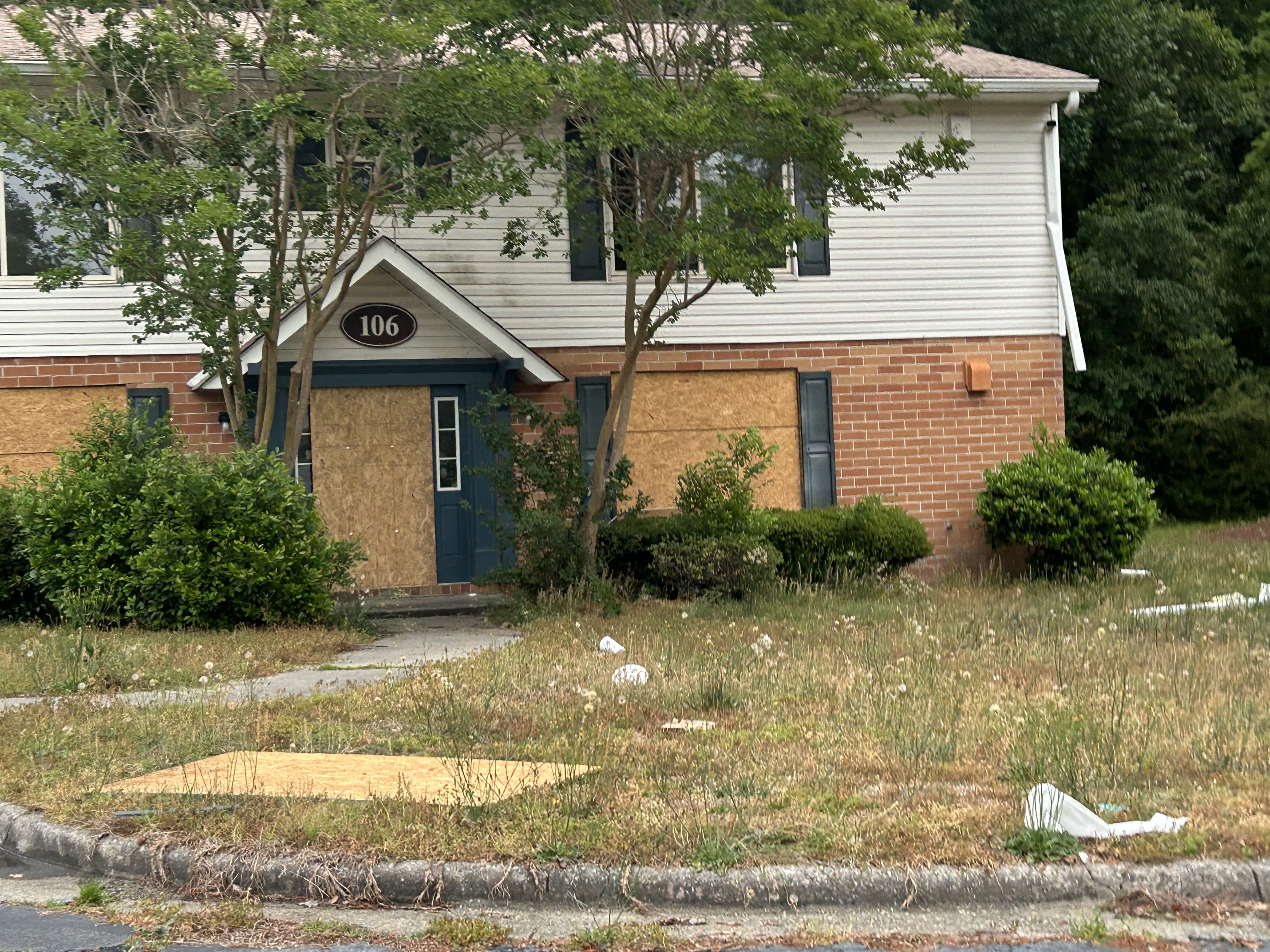 Macon property before board-ups - broken windows and exposed openings