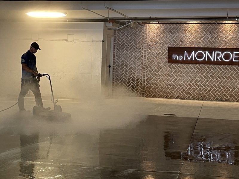Washing a level of an occupied parking deck, vehicles still in place