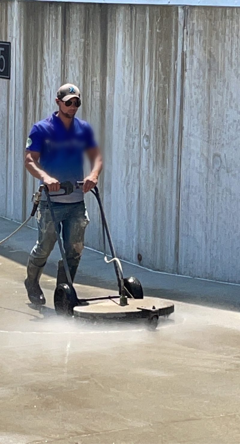 Surface cleaner working a concrete elevation on a commercial site